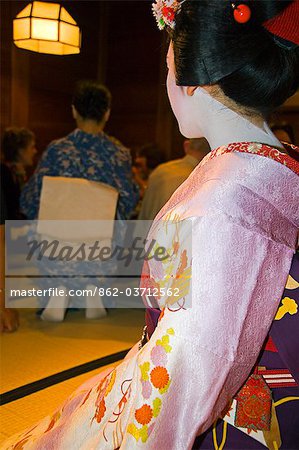 Japan,Honshu Island,Kyoto Prefecture,Kyoto City. Maiko (Trainee Geisha) entertainment at a formal dinner banquet.