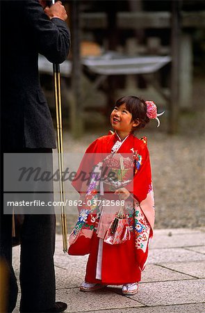Japan,Honshu Island,Kyoto. Girl dressed in a traditional Kimono visiting the Matsuo Shrine.