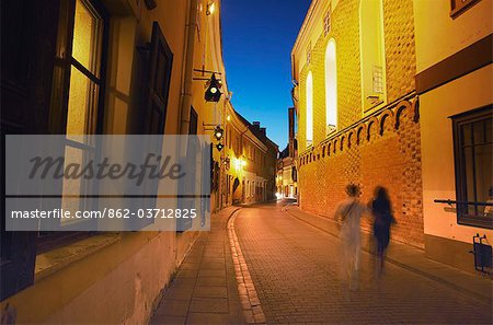 Lithuania, Vilnius, Two People Walking Along Stikliu Gatve At Dusk