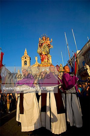 Malta, Zurrieq; Men carrying the statue of the Madonna, the patron saint during the annual parade.