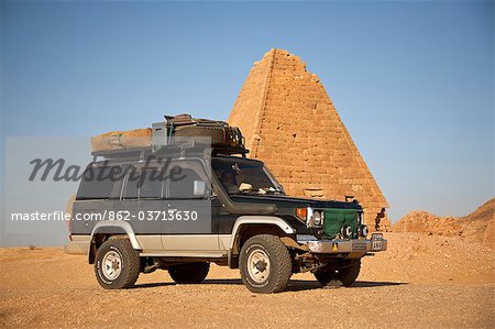 Sudan, Karima. A 4x4 parked by the pyramids at Karima.