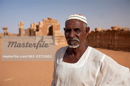 Sudan, Nagaa. The solitary guide at the remote ruins of Nagaa stands in front of the ruins.