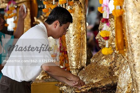 Bangkok, Thailand. Praying at a buddhist temple