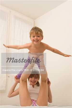 Brother and Sister Playing Airplane