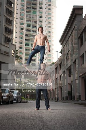 Two Acrobats Performing Outside, Taipa, Macau, China