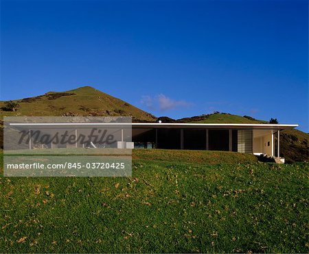 Exterior of single-storey, flat-roofed modernist residence with pilotis in landscape. Architects: Fearon Hay Architects