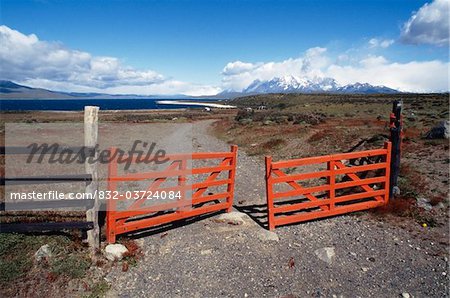 Red gate over dirt road