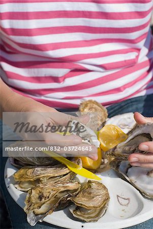 Woman eating oysters in Cancale, Close Up