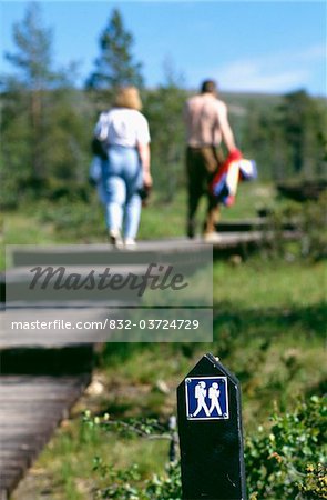 Couple walking on wooden path