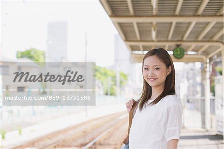 Japanese Teenage Girl Waiting On Platform