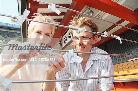Couple With Fortune Telling Paper In Temple