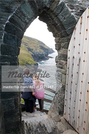 England, Cornwall. Boy and Girl at the doorway to Tintagel Castle.