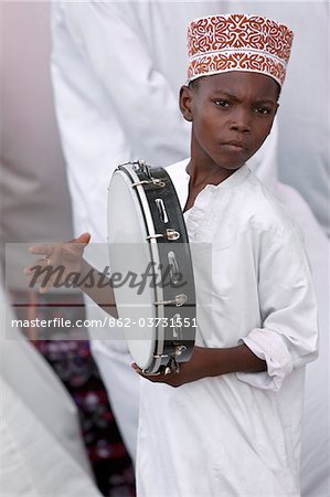 Kenya. A Muslim boy from Lamu keeps rhythm with a tambourine during Maulidi, celebration of Prophet Mohammed s birthday.