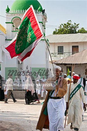 Kenya. A flag bearer prepares to leave the Riyadha Mosque on procession to mark Maulidi; celebration of Prophet Mohammed s birthday.