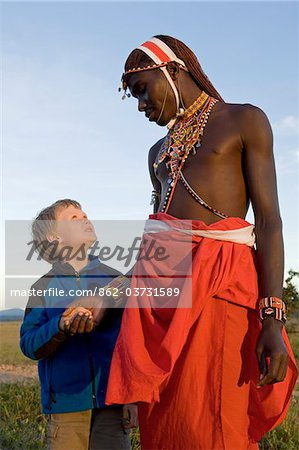 Kenya, Laikipia, Lewa Downs. A young boy on a family safari with one of the Laikipiak Maasai guides. Kenya, Laikipia, Lewa Downs. A young boy on a family safari with one of the Laikipiak Maasai guides.