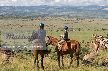 Kenya, Laikipia, Lewa Downs. Horse riding during a family safari at Lewa Downs.