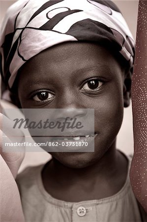 Mozambique, Ihla de Moçambique, Stone Town. A young muslim boy smiles at the camera