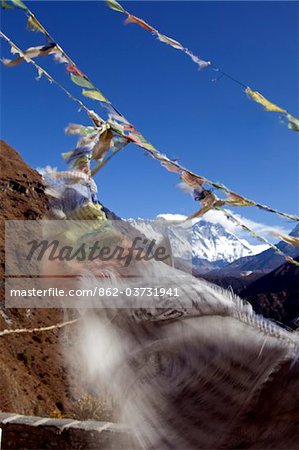 Nepal, Everest Region, Khumbu Valley. Buddhist prayer flags adorn the trail and frame Mount Everest in the background