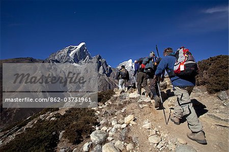 Nepal, Everest Region, Khumbu Valley. A group of trekkers make their way up towards Dughla through the Periche Valley.