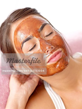 Brunette woman with a chocolate mask
