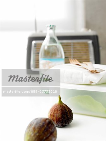 Figs, food storage container and bottle of water