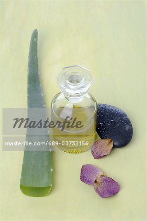 Aloe, rose petals, oil and stone