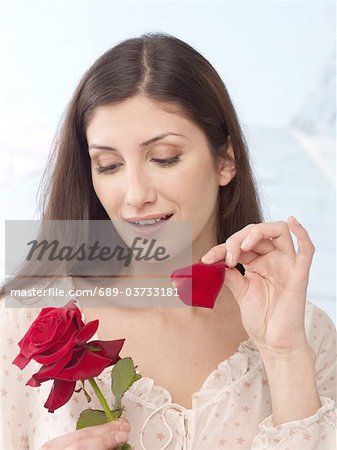 Woman plucking rose petals