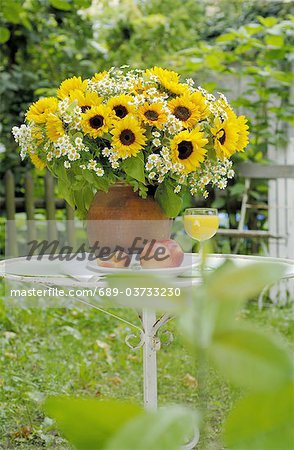Bouquet de fleurs de camomille et de tournesols sur table de jardin