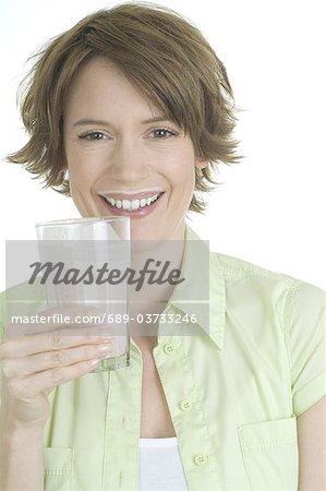 Smiling woman drinking milk shake