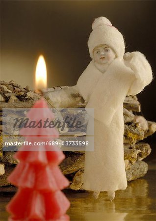 Christmas decoration with figurine and candle
