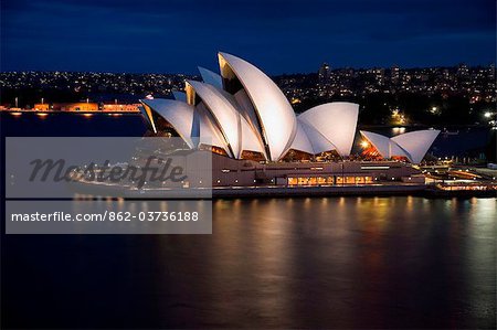 Australia, New South Wales, Sydney.  View across Sydney harbour to the Opera House at dusk.