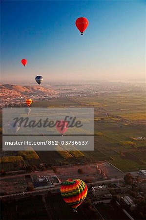 Egypt, Qina, Al Asasif, Eight hot air balloons over the Valley of the Kings and Queens with Luxor and the River Nile