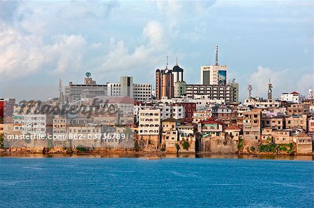 Kenya, Mombasa. The water front of the old dhow harbour in Mombasa with modern high rise buildings in the background.