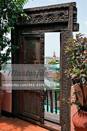 Tanzania, Zanzibar, Stone Town. The Anglican Cathedral Church of Christ through an old door at the boutique hotel 236 Hurumzi