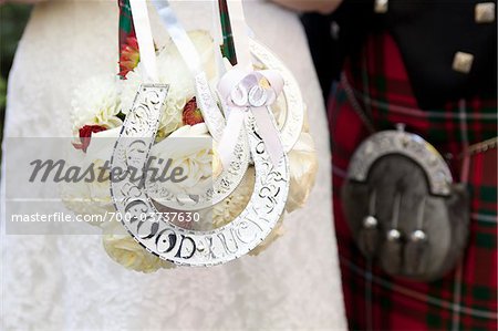 Bride and Groom with Bouquet Decorated with Horseshoes