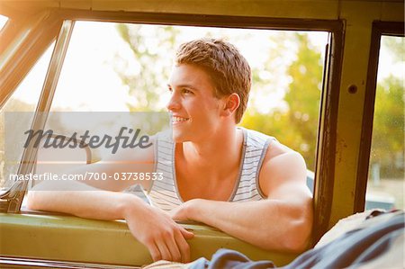 Teenage Boy Leaning on Car Door