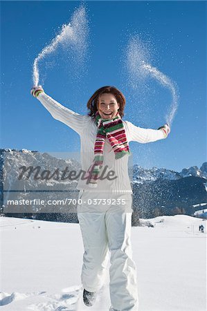 Woman Tossing Snow in Air
