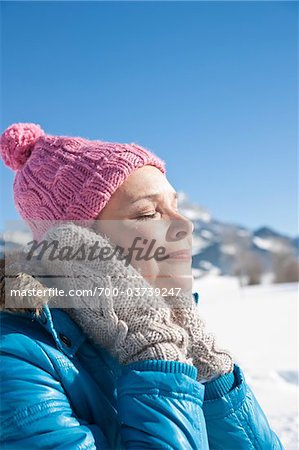 Woman Covering Ears Outdoors in Winter