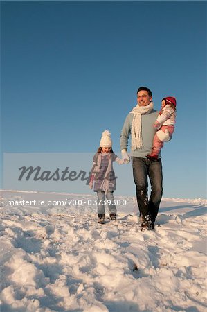 Man with Daughters Outdoors in Winter
