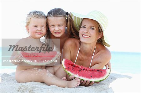 Mother and Daughters with Watermelon on Beach