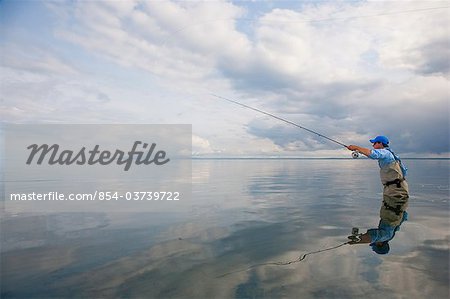 Angler fly fishing in Bristol Bay near Crystal Creek Lodge, King Salmon, Southwest Alaska, Summer
