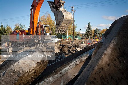 Excavator digs up the road at Lake Otis Parkway near East 72nd Ave. in Anchorage, Southcentral Alaska, Autumn