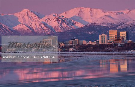 Anchorage and the Chugach Mountains reflect in Cook Inlet at sunset, Southcentral Alaska, Winter