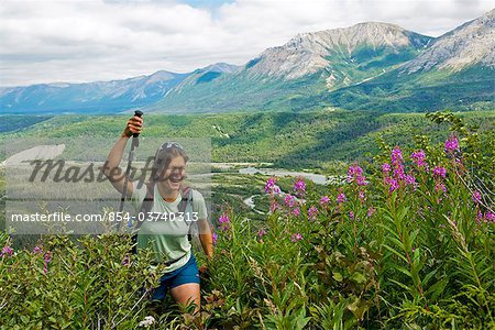 Woman hiking up the Sediment Creek trail along the Tatshenshini River in Tatshenshini-Alsek Provincial Park, British Columbia, Canada, Summer