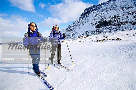 Two skiers in the mountains.