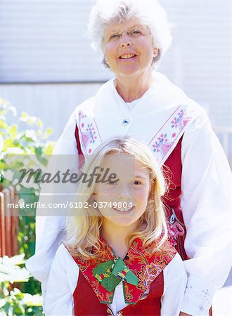 Portrait of a girl and a woman wearing national costumes.