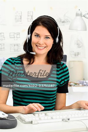 A woman with headset in an office.