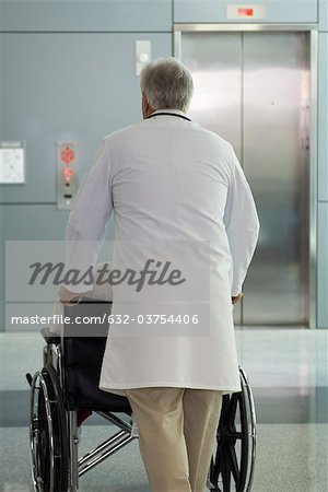 Médecin patient pousser en fauteuil roulant