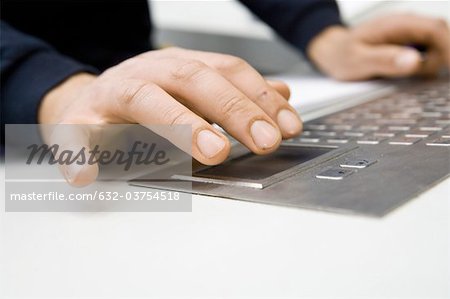 Hands using keyboard on control panel