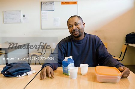 Factory worker having lunch in breakroom